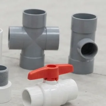 Grey PVC cross and tee fittings with a red-handled ball valve